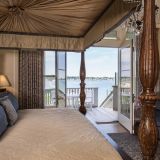 Bask in natural light and ocean breezes in your sand, sea, and sky-toned Martha's Vineyard Guest Room. Wake beside a glowing fireplace in a full-canopied four-poster king bed decorated with plush linens inside your private ocean villa