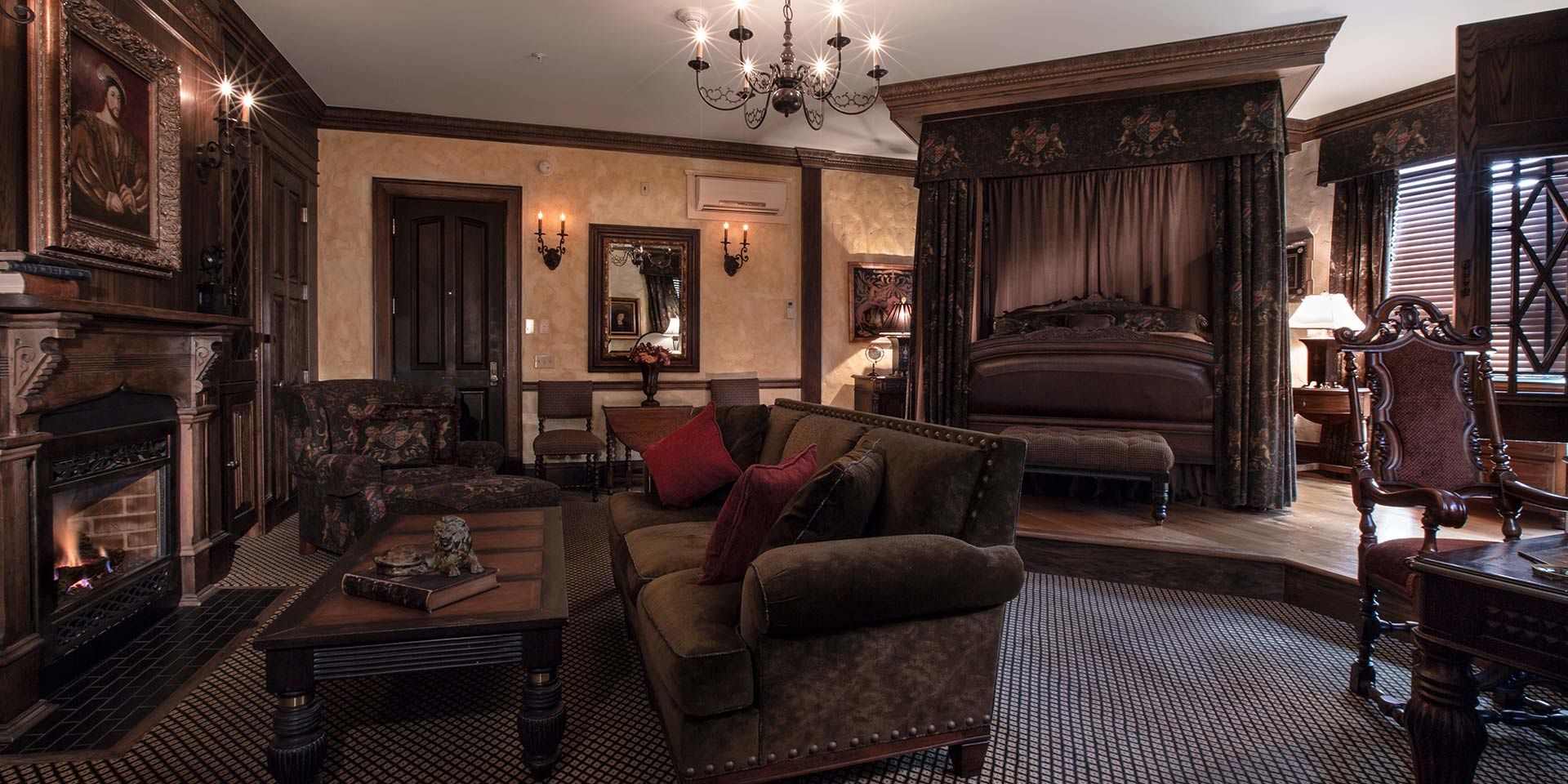 The English Tudor Guest Room boasts strikingly beautiful carved woodwork with traditional linen-fold oak panels and handcrafted stucco walls. Experience Medieval grandeur in the living area while you sit among a suede couch or overstuffed chair facing the