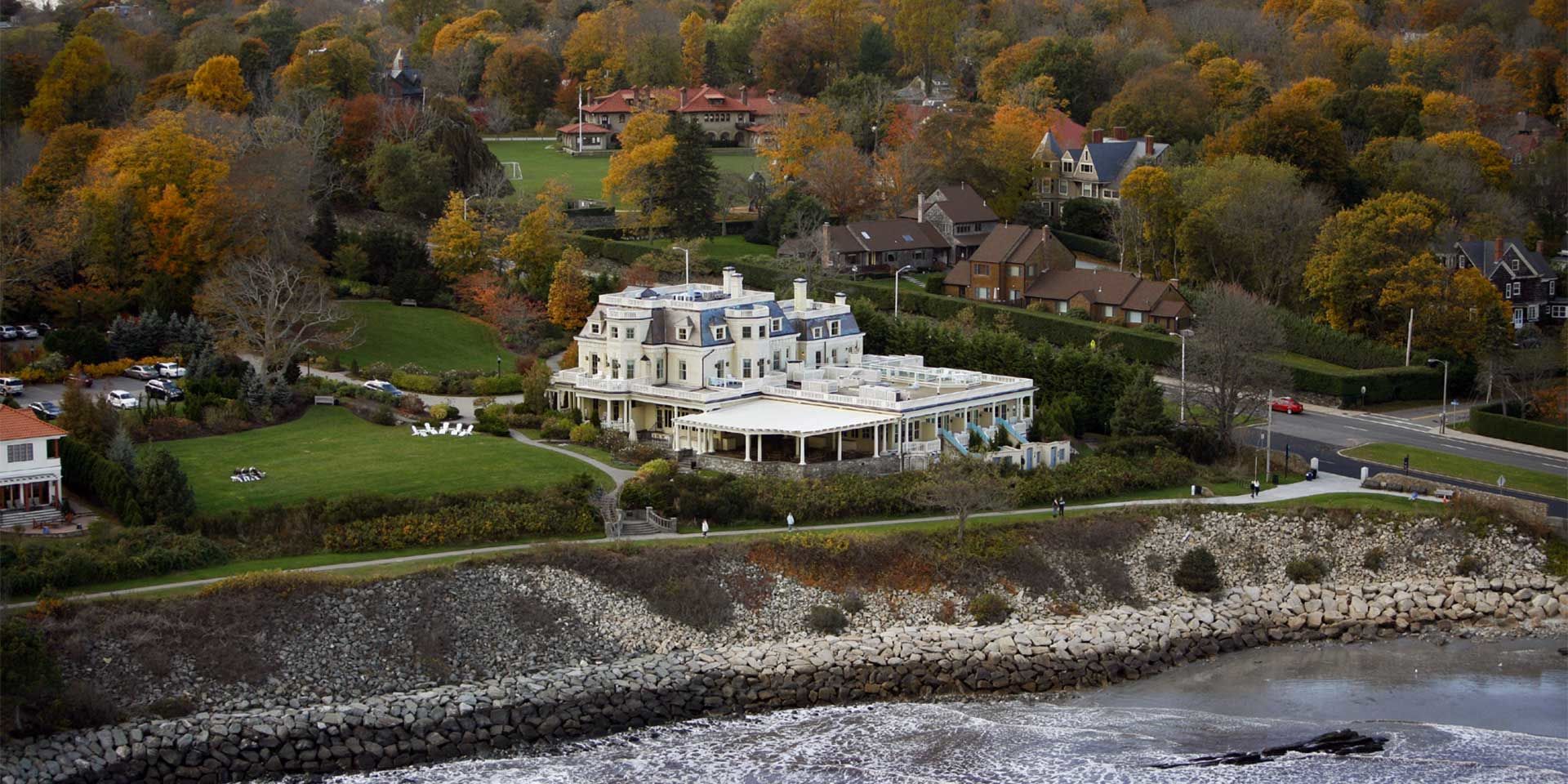 Aerial view of The Chanler at Cliff Walk with Fall Foliage and the Newport Pell Bridge in the background
