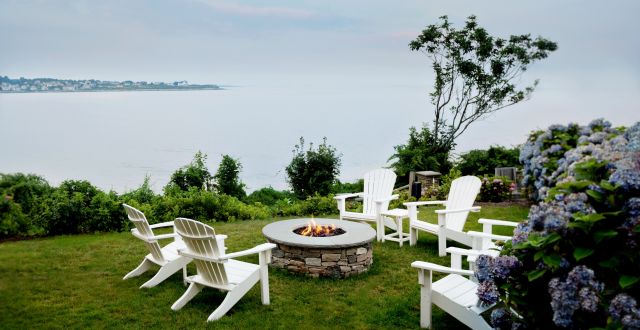 backyard view of ocean with a fire pit at The Chanler at Cliff Walk 