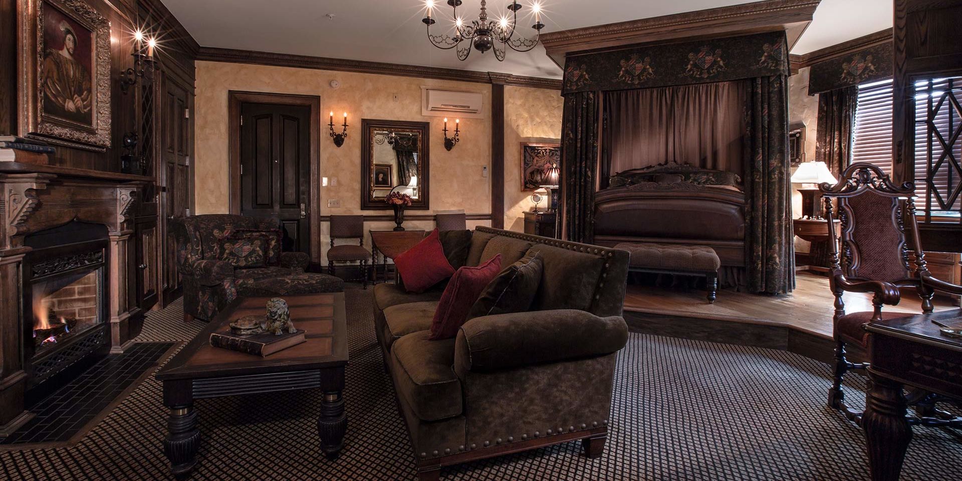 The English Tudor Guest Room boasts strikingly beautiful carved woodwork with traditional linen-fold oak panels and handcrafted stucco walls. Experience Medieval grandeur in the living area while you sit among a suede couch or overstuffed chair facing the