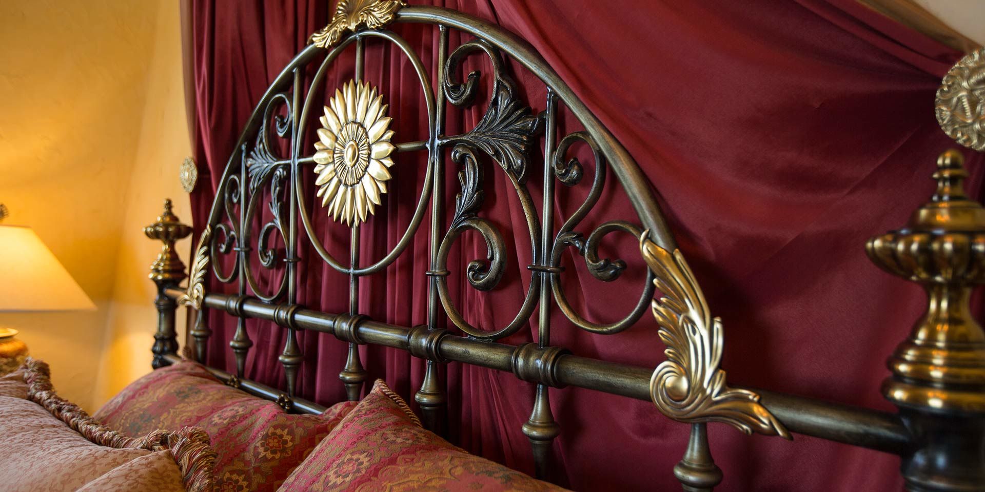 The California king-sized iron bed inside the Mediterranean Guest Room