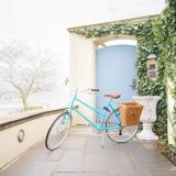 A Bicycle In Front Of A House