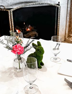A Table With Glasses And Flowers